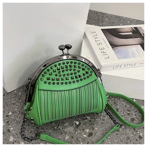 Detail view of bright green shell bag featuring black rivets and silver chain tassels