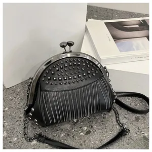 Close-up of black PU leather shell bag featuring rivet details and metal chain strap