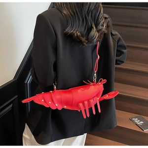 Close-up of the lobster-shaped red crossbody bag with creative crustacean design details