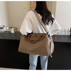 Detail of khaki fitness travel bag featuring side zip pocket and adjustable shoulder strap