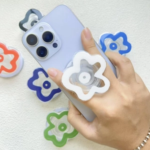 Close-up of colorful flower-shaped phone grip with transparent base held in hand