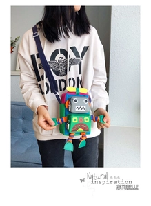 Enfant portant un sac bandoulière robot coloré avec panneaux en tissu et sangle bleue