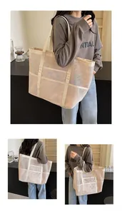 Close-up of the breathable mesh fabric and reinforced straps of the beige beach tote bag