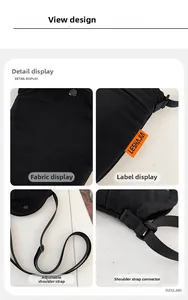 Detail view of black canvas crossbody bag featuring orange logo label and adjustable strap