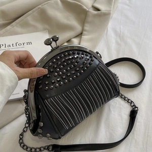 Retro black leather frame bag featuring silver studs, fringe chains, and crossbody strap