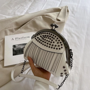 White shell frame bag with stud details and long metal chain fringe in rock style