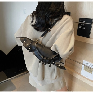 Close-up of a creative lobster-shaped black PU leather crossbody bag with metal rivets
