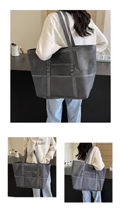 Close-up of grey mesh tote bag showing large capacity mesh texture and side pockets