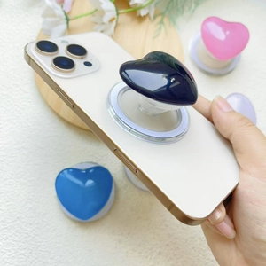 Magnetic heart-shaped MagSafe phone grip in black, blue, pink, and purple colors