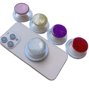 Magnetic glitter resin phone socket stand in five colors mounted on a smartphone