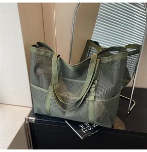 Detail of army green mesh tote bag with multiple pockets and durable nylon straps