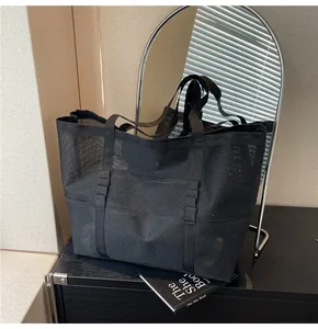 Detail view of breathable black mesh tote bag with reinforced nylon handles for beach and gym