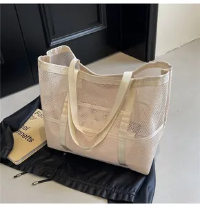 Detailed macro shot of beige mesh tote bag showing breathable fabric and reinforced straps