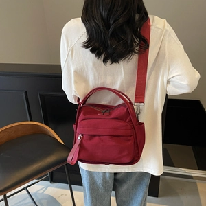 Versatile dark red lightweight nylon crossbody bag for women featuring multiple compartments
