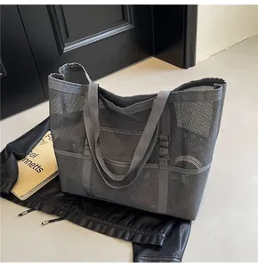 Detailed close-up of dark grey mesh tote bag with breathable texture and sturdy dual handles