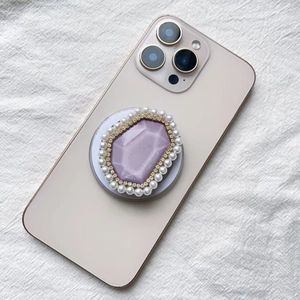 Macro shot of Magsafe phone socket with purple crystal, rhinestones and white pearls
