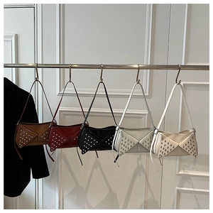 Cinq sacs à bandoulière en cuir clouté de couleurs marron, rouge, noir, gris et blanc