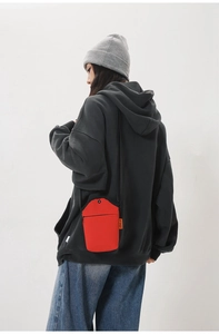 Streetwear style red canvas crossbody phone bag featuring functional front zipper pocket