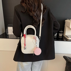 White lychee leather handbag with pink mini coin purse and red woven details