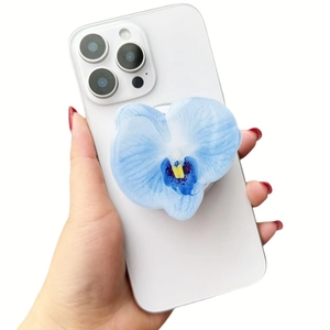 Close-up of a blue orchid floral MagSafe phone grip on a white smartphone device