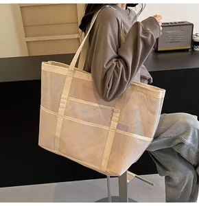 Close-up of lightweight mesh beach tote with wide shoulder straps and front pockets