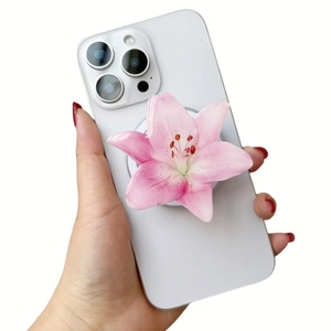 Detail showing hand holding a smartphone with a 3D pink lily flower acrylic phone stand