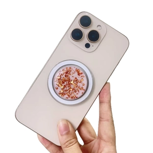Magnetic MagSafe phone socket with gold foil flakes on a light gold iPhone back