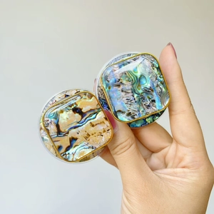 Close-up of telescopic phone stand with colorful abalone shell texture and gold rim
