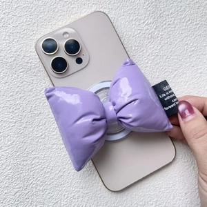 Close-up of a purple bow magnetic phone grip with glossy 3D padded leather design