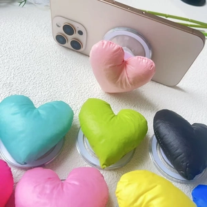 Colorful puffy heart phone socket stand with soft fabric padding and adhesive base