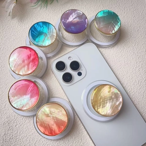 Colorful shell-texture phone grip with gold rim on white smartphone with gradient options