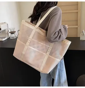 Close-up of beige mesh tote bag showing fine breathable texture and reinforced straps