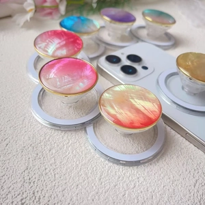 Detail of gradient shell texture magnetic phone sockets with golden rim and MagSafe base