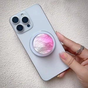 Detail of colorful seashell texture magnetic phone grip with iridescent pink mother-of-pearl