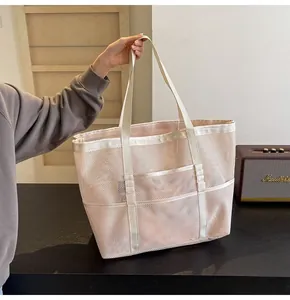 Close-up of mesh tote bag featuring reinforced straps and a functional outer pocket