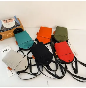 Group of colorful mini canvas crossbody phone bags in various street style colors