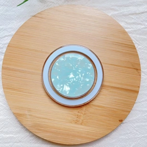 Detail of blue shell pattern MagSafe magnetic phone holder on a bamboo tray