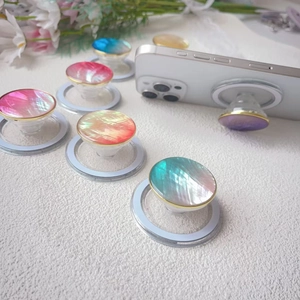Magnetic shell phone socket with iridescent gradient finish and gold rim on white smartphone