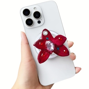Detail of red floral phone socket with large purple gem and colorful rhinestones