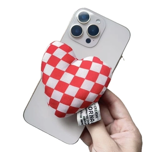 Red and white checkered fabric heart-shaped magnetic phone grip on a smartphone