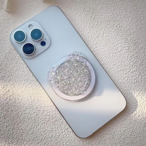 Close-up of glitter heart Griptok with silver sequins on white smartphone back