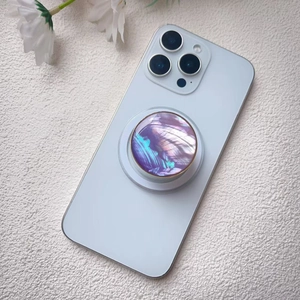 Macro shot of colorful shell texture phone grip stand on a white smartphone