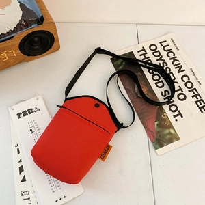 Minimalist red canvas crossbody phone bag for women with adjustable black shoulder strap