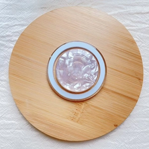Top view of MagSafe phone stand with iridescent lavender seashell pattern in white ring