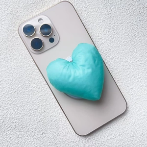 Close-up of 3D puffy fabric heart phone socket in tiffany blue on mobile phone
