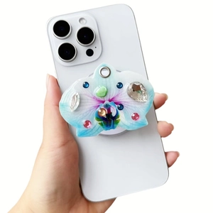 Detail of orchid-shaped magnetic phone socket with colorful rhinestones on a smartphone