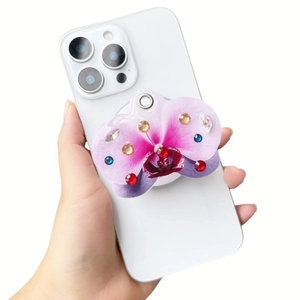Detail of pink orchid phone grip with crystals on white smartphone back