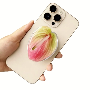 Detail of red anthurium acrylic magnetic phone grip holder on a gold iPhone