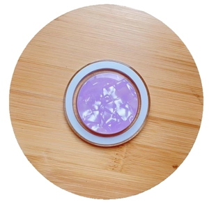 Purple shell pattern MagSafe magnetic phone holder with silver frame on wooden tray