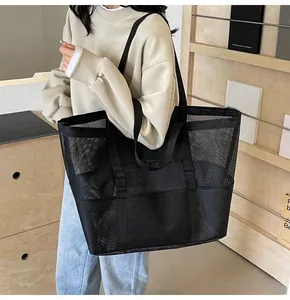 Close-up of a black mesh tote bag showing large capacity and breathable net material texture